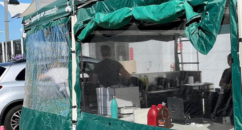 A photo of a sausage sizzle stall by a charity outside the Belmont, WA store at Bunnings.