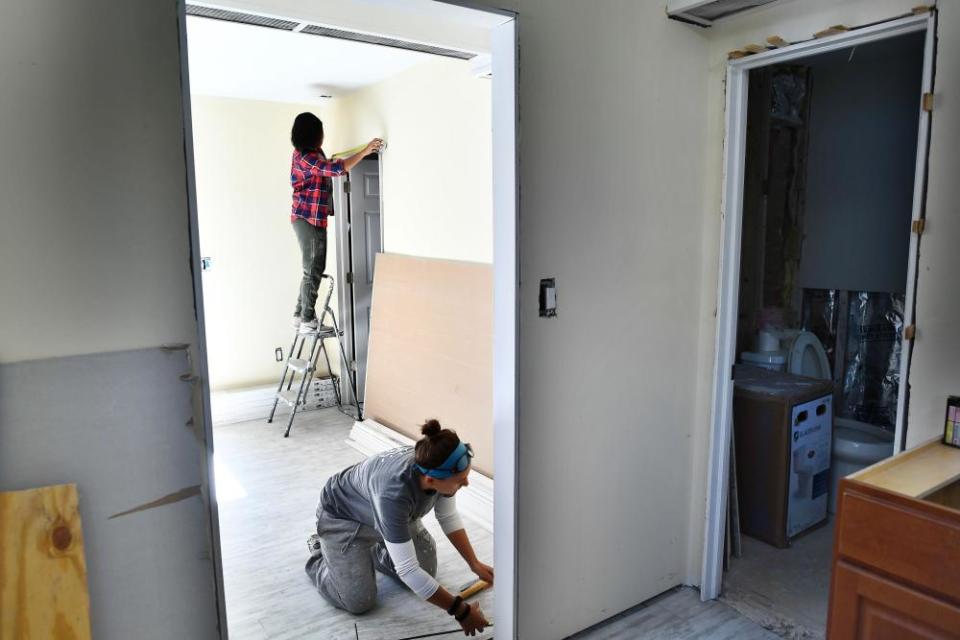 Members of AmeriCorps install a door frame in a house damaged by Hurricane Sandy in Brooklyn in 2017.