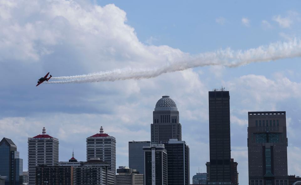 A Matt Younkin Twin Beech aircraft left a smoke trail while flying over the downtown skyline at Thunder Over Louisville. April 22, 2023.