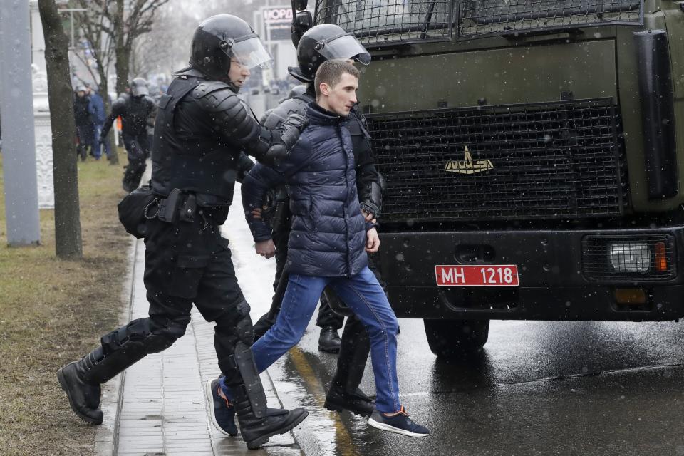 Belarus police detain an activist during an opposition rally in Minsk, Belarus, Saturday, March 25, 2017. A cordon of club-wielding police blocked the demonstrators' movement along Minsk's main avenue near the Academy of Science. Hulking police detention trucks were deployed in the city center. (AP Photo/Sergei Grits)