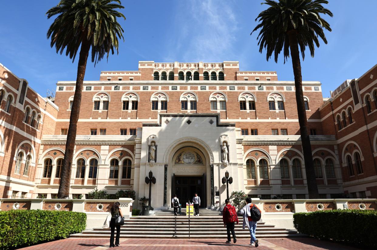 People walk on the campus of the University of Southern California in Los Angeles on March 21, 2024.