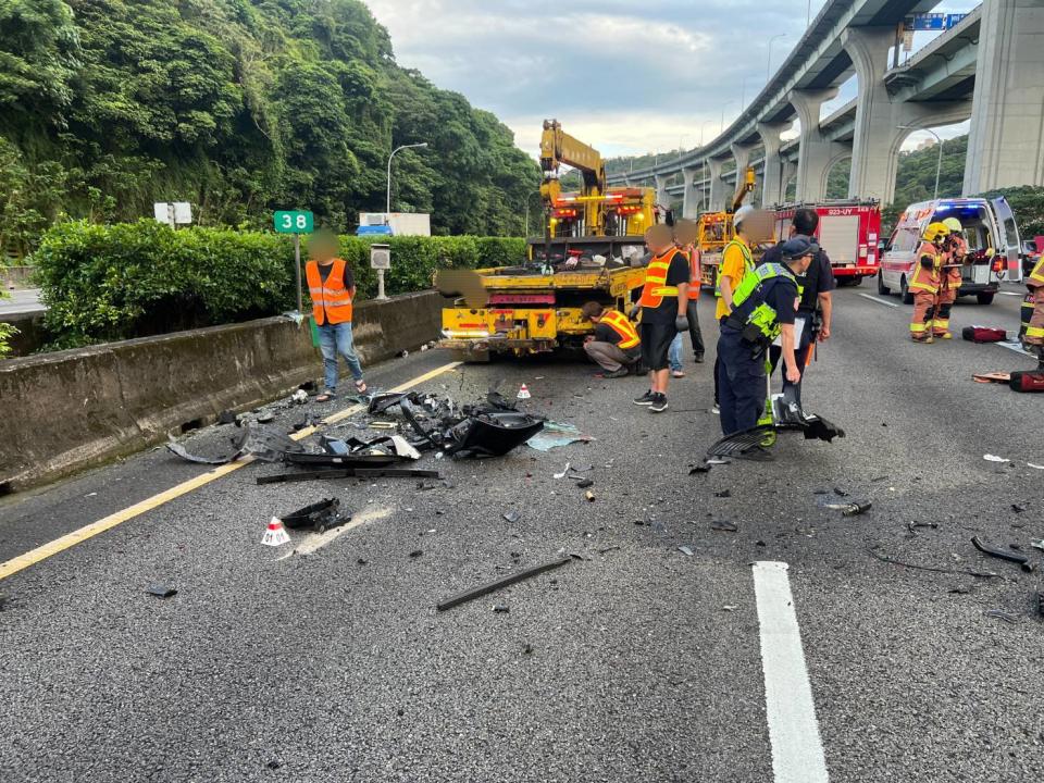 國道1號南下38公里林口段15日凌晨4時41分發生2部車碰撞，拖吊車現場處理時，後方一輛自小客車不明原因撞上拖吊車，車子零件四散，自小客車男駕駛與兩名女乘客受傷，男駕駛送醫急救不治，詳細原因待警方進一步調查釐清。（翻攝照片／中央社）