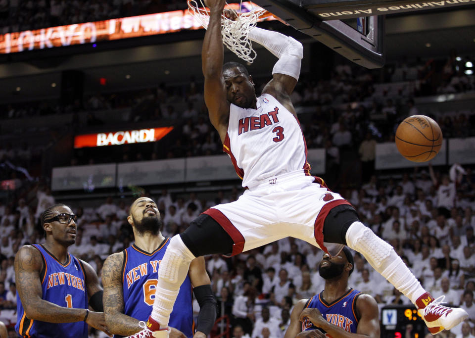 FILE - Miami Heat's Dwyane Wade (3) scores on a dunk as New York Knicks' Amare Stoudemire (1) and Tyson Chandler (6) look on in the first half of an NBA basketball game in the first round of the Eastern Conference playoffs in Miami, April 28, 2012. Wade was announced Friday, Feb. 17, 2023, as being among the finalists for enshrinement later this year by the Basketball Hall of Fame. The class will be revealed on April 1. (AP Photo/Lynne Sladky, File)