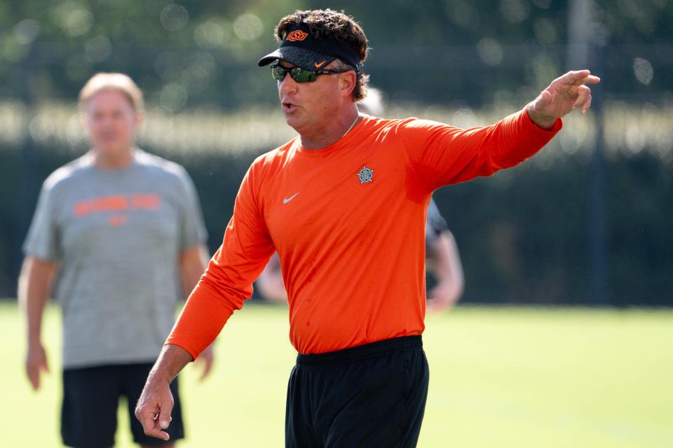 Head coach Mike Gundy walks onto the field during Oklahoma State football practice in Stillwater, Oklahoma, Saturday, Aug. 3, 2024.