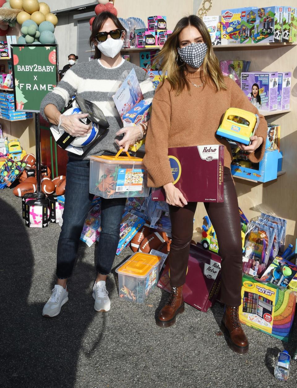<p>Jennifer Garner and Jessica Alba are put to work on Sunday during Baby2Baby's Holiday Drive-Thru Distribution presented by FRAME in Los Angeles. </p>