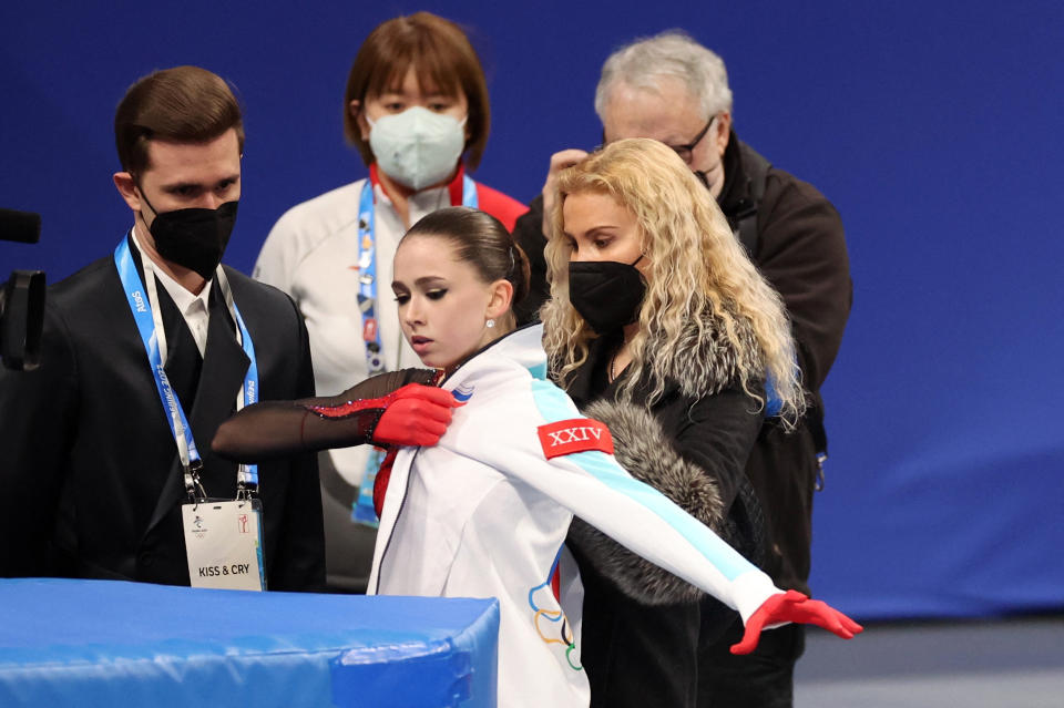 Kamila Valieva with with coaches Eteri Tutberidze and Daniil Gleikhengauz after finishing in the women's figure skating at the Beijing Winter Olympics