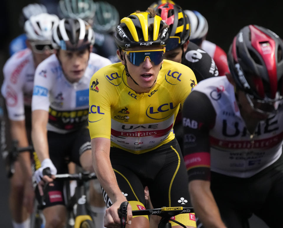 Slovenia's Tadej Pogacar, wearing the overall leader's yellow jersey, is followed by Belgium's Wout Van Aert, right, and Denmark's Jonas Vingegaard, wearing the best young rider's white jersey, as they climb during the eighteenth stage of the Tour de France cycling race over 129.7 kilometers (80.6 miles) with start in Pau and finish in Luz Ardiden, France,Thursday, July 15, 2021. (AP Photo/Christophe Ena)