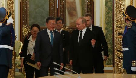 Russian President Vladimir Putin and South Korean President Moon Jae-in enter a hall prior to the talks at the Kremlin in Moscow, Russia June 22, 2018. REUTERS/Sergei Karpukhin