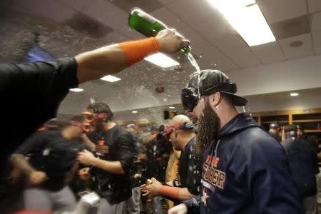 Oct 6, 2015; Bronx, NY, USA; Houston Astros starting pitcher Dallas Keuchel (center) celebrates with teammates in the locker room after defeating the New York Yankees in the American League Wild Card playoff baseball game at Yankee Stadium. Houston won 3-0. Mandatory Credit: Adam Hunger-USA TODAY Sports