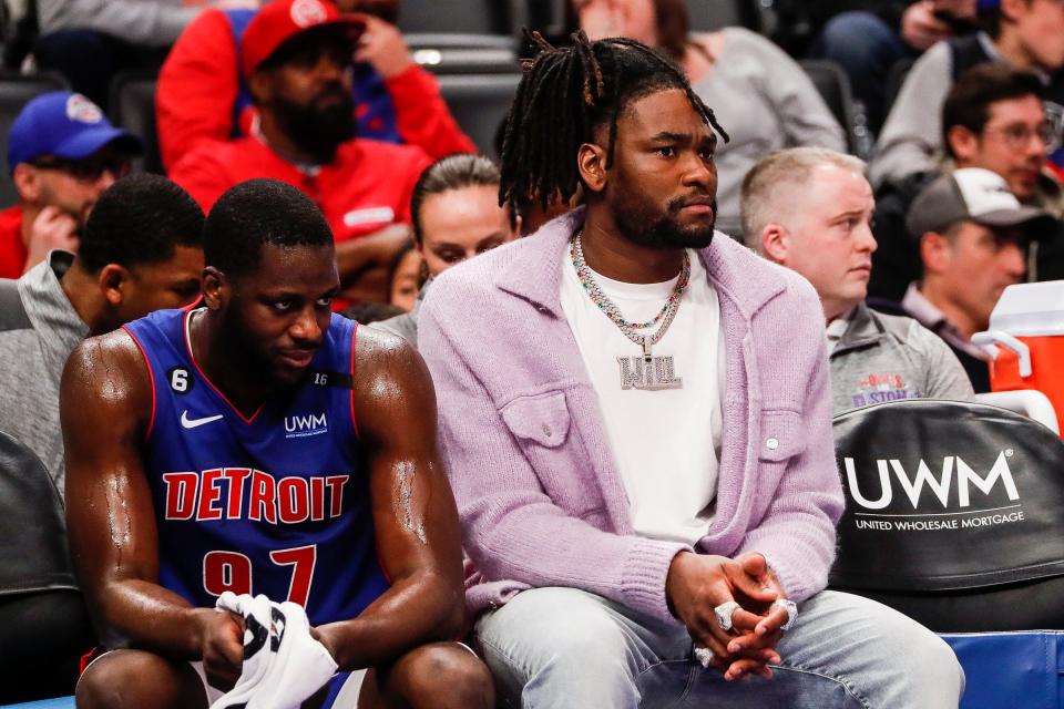 Detroit Pistons power forward Isaiah Stewart, right, watches from the bench next to forward Eugene Omoruyi during the second half of a game at Little Caesars Arena in Detroit on Thursday, March 9, 2023.