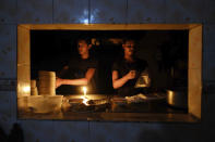 Staff at an eatery work by candle light after a failure in Bangladesh's national power grid plunged much of the country into a blackout in Dhaka, Bangladesh, Tuesday, Oct.4, 2022. (AP Photo/Mahmud Hossain Opu)