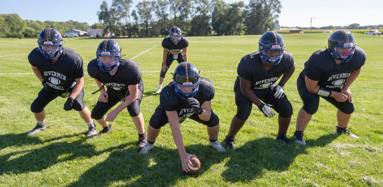 Du/Pec Rivermen linemen, from left, Max Russow, Kaden Degner, Eric Kormoczy, Briaun Green and Tyler Lucas pose in front of AJ Mulcahy on Wednesday, Aug. 31, 2022, at Pecatonica High School in Pecatonica. They all helped Mulcahy gain 235 yards rushing last week.