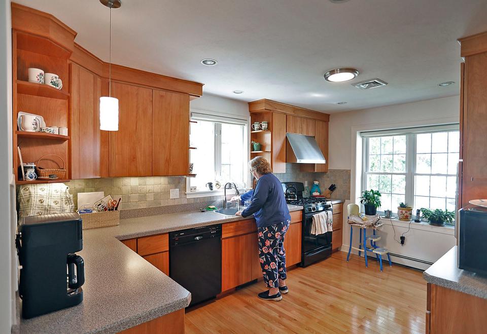 Kathy Lavery in her new open plan kitchen Thursday, Aug. 25, 2022. It was built in 2004.