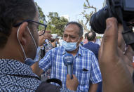 Driss Radi, the father of Omar Radi, speaks to the media in front of the Casablanca Courthouse, in Casablanca, Morocco, Tuesday, Sept. 22, 2020, on the first day of the hearing of journalist and activist Omar Radi. The arrest of journalist Omar Radi follows numerous summons following a police investigation into suspicion of receiving funds linked to foreign intelligence. The investigation came after rights group Amnesty International accused Morocco of using Israeli-made spyware to snoop on its phone. (AP Photo/Abdeljalil Bounhar)