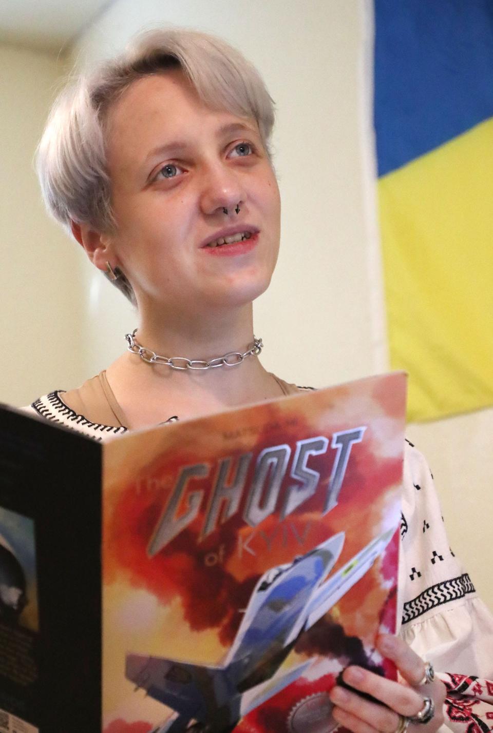 Stetson University student Genevia Gayden, who moved to DeLand from Ukraine, reads "Ghost of Kyiv," while hanging out with roommates in their apartment recently.