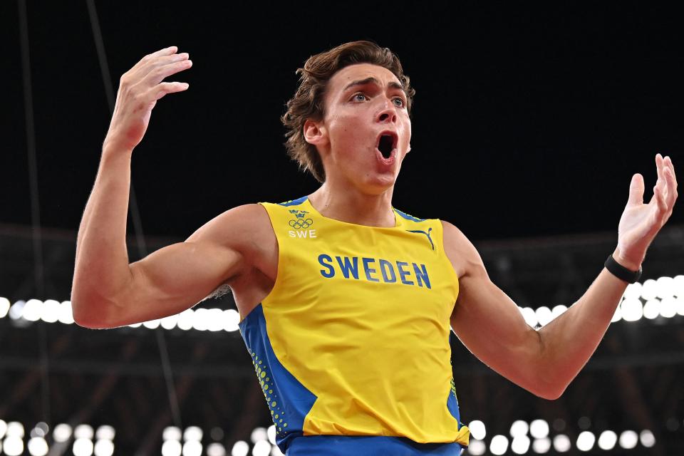 <p>Sweden's Armand Duplantis celebrates after clearing the bar to attempt the gold medal as he competes in the men's pole vault final during the Tokyo 2020 Olympic Games at the Olympic Stadium in Tokyo on August 3, 2021. (Photo by Ben STANSALL / AFP) (Photo by BEN STANSALL/AFP via Getty Images)</p> 