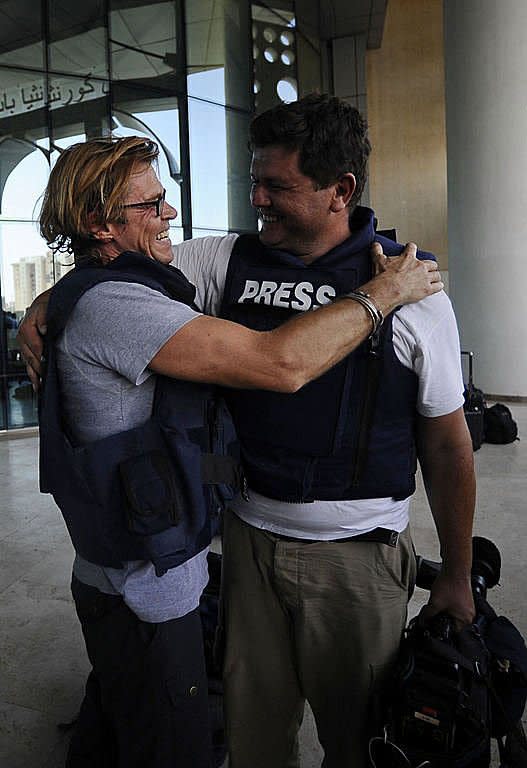 A journalist freed from Rixos Hotel hugs a colleague upon arrival to Corinthia Hotel in the Libyan capital Tripoli. Some 30 mostly foreign journalists who had been held against their will in Tripoli's Rixos Hotel by guards loyal to Libya's strongman Moamer Kadhafi were freed