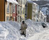 A woman shovels out after a winter storm hit St.John's. N.L., Sunday, Jan.5, 2014. THE CANADIAN PRESS/Paul Daly