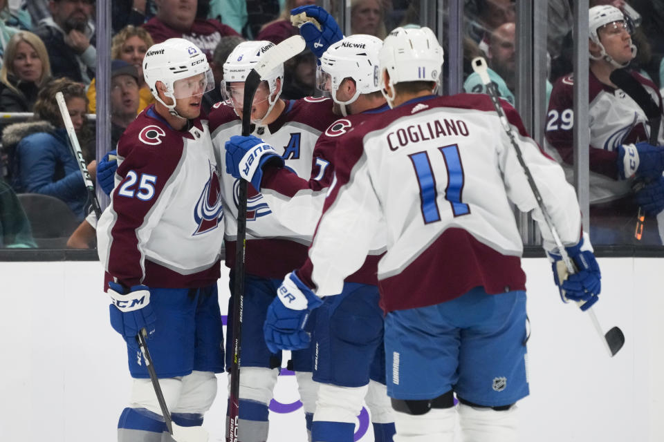 Colorado Avalanche right wing Logan O'Connor (25) celebrates his goal against the Seattle Kraken with teammates Cale Makar (8), Devon Toews (7) and Andrew Cogliano (11) during the second period of an NHL hockey game Tuesday, Oct. 17, 2023, in Seattle. (AP Photo/Lindsey Wasson)