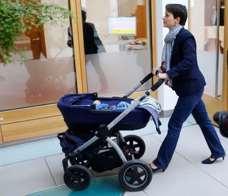 Frauke Petry, former chairwoman of the anti-immigration party Alternative fuer Deutschland (AfD), walks with her baby through Berlin, Germany, October 18, 2017. REUTERS/Hannibal Hanschke