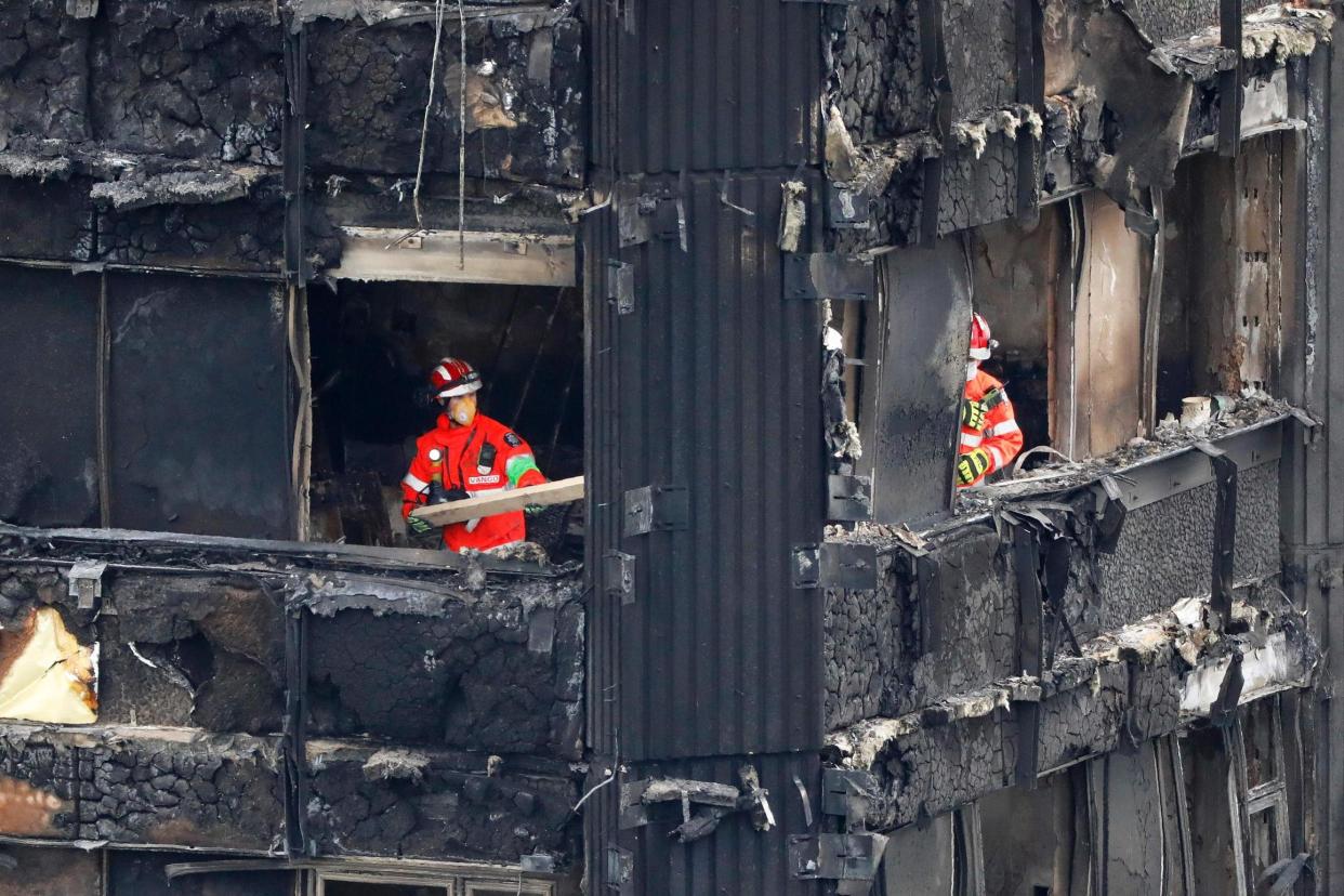 Recovery: Members of the emergency services in the middle floors: AFP/Getty Images