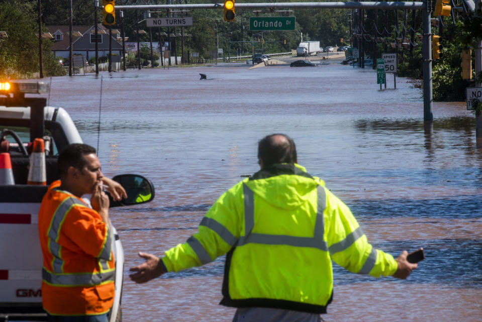 People take a look at the 206 route partially flooded as a result of the remnants of Hurricane Ida in Somerville, N.J., Thursday, Sept. 2, 2021. (AP Photo/Eduardo Munoz Alvarez)