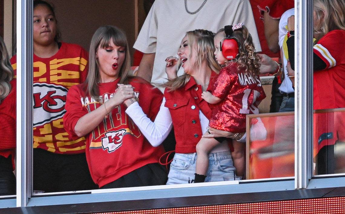 Pop star Taylor Swift and Brittany Mahomes shake hands after a touchdown by Chiefs receiver Rashee Rice during Sunday’s game against the Los Angeles Chargers at GEHA Field at Arrowhead Stadium.