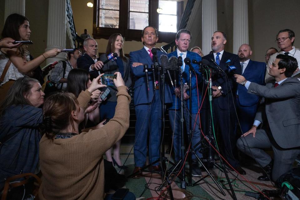 Ken Paxton’s defense attorneys, from left, Tony Buzbee, Dan Cogdell, and Mitch Little speak to members of the Texas Capitol press corps following the Senate’s vote to acquit Attorney General Ken Paxton of 16 articles of impeachment on Sept. 16, 2023.