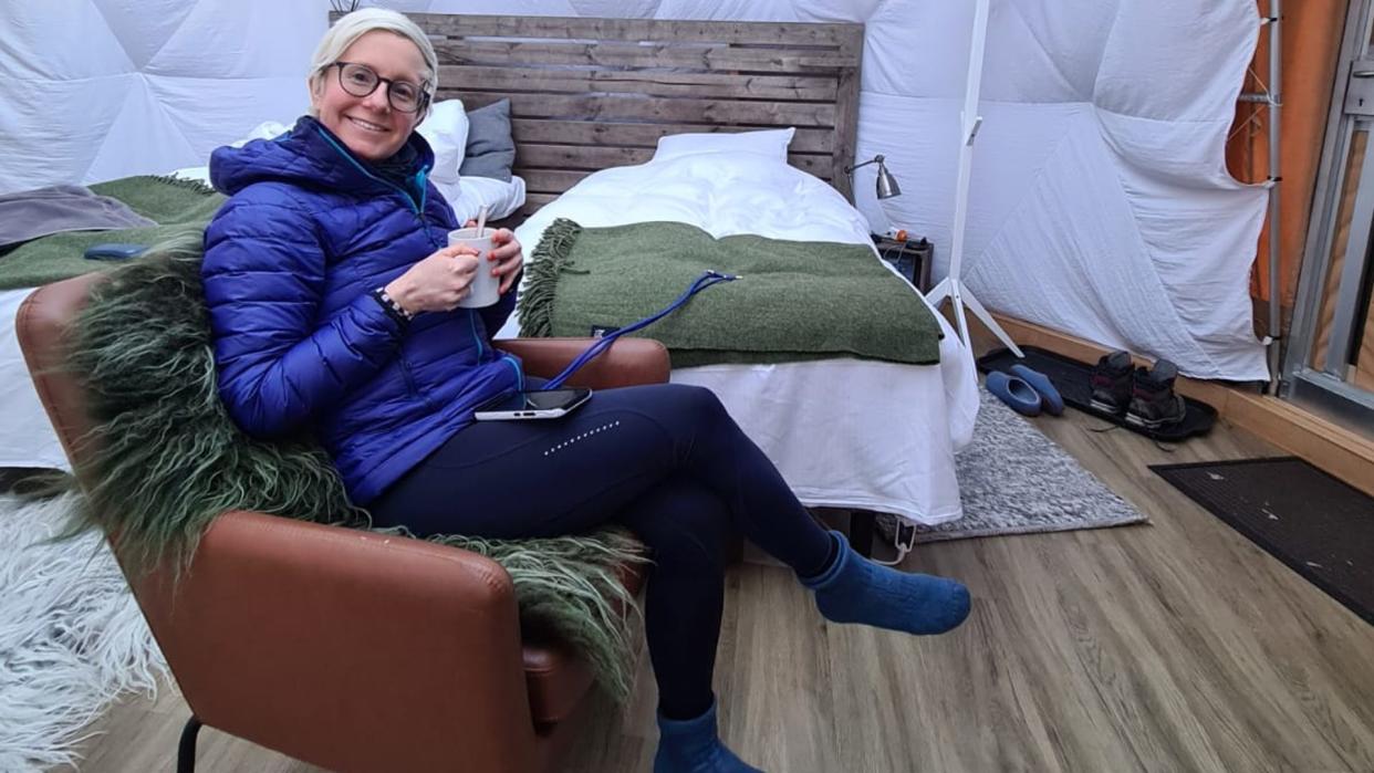 Woman sitting in a tent in the arctic circle