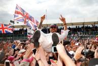 Britain Formula One - F1 - British Grand Prix 2016 - Silverstone, England - 10/7/16 Mercedes' Lewis Hamilton celebrates with fans after winning the race REUTERS/Andrew Boyers Livepic