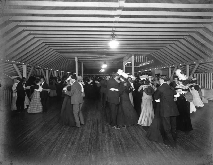 Interior view of a dance hall at Manhattan Beach amusement park in Denver, Colorado; shows men and women dancing. ( Denver Public Library Special Collections, X-19534)
