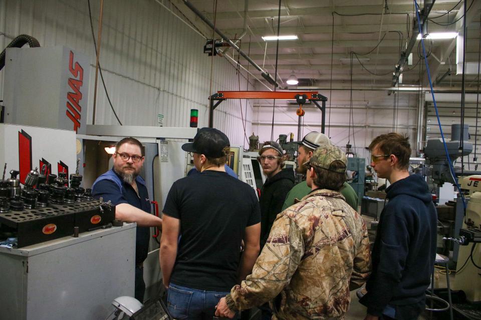 DeLoss Dulohery (left) instructs a course on CNC Mills Jan. 20. Dulohery teaches in the machine tool technology program at Salina Area Technical College.
