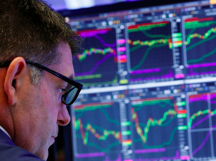 FILE PHOTO - A trader works on the floor of the New York Stock Exchange shortly after the opening bell in New York, U.S., June 27, 2017.  REUTERS/Lucas Jackson