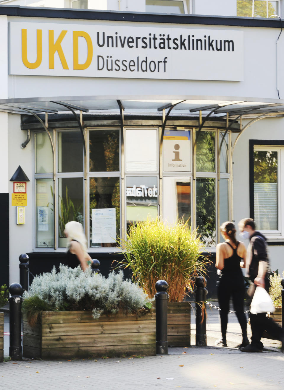 People enter the University Hospital in Duesseldorf, Germany, Tuesday, Sept. 15, 2020. German authorities say a hacker attack caused the partial failure of IT systems at a major hospital in Duesseldorf, and a woman who needed urgent admission died after she had to be taken to another city for treatment. (Roland Weihrauch/dpa via AP)