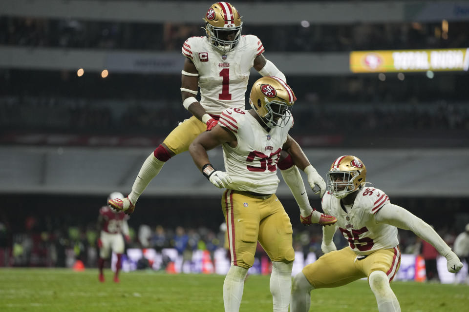 San Francisco 49ers defensive tackle Kevin Givens, center, celebrates his sack with teammates cornerback Jimmie Ward (1) and defensive end Drake Jackson during the second half of an NFL football game against the Arizona Cardinals, Monday, Nov. 21, 2022, in Mexico City. (AP Photo/Eduardo Verdugo)