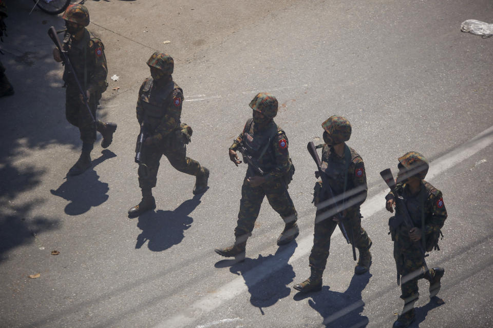 FILE - The Army moves in to disperse protesters during a demonstration in Yangon, Myanmar, Sunday, March 7, 2021. (AP Photo, File)