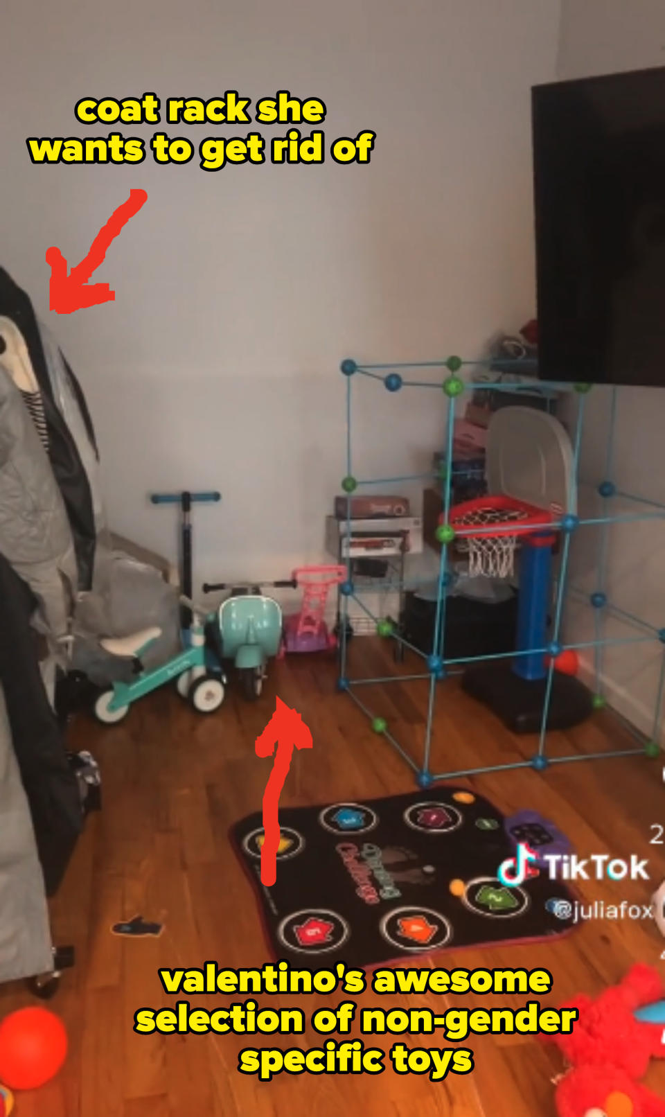 A coat rack that Julia wants to get rid off is on the left side of the room and her son Valentino's non-gender specific toys, including a mini basketball hoop and a scooter, fill the rest of the space