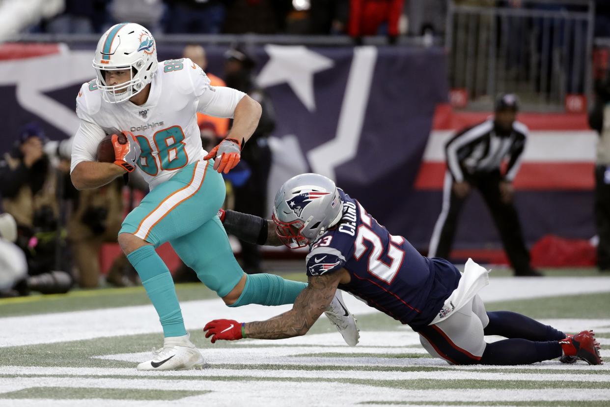 Miami Dolphins tight end Mike Gesicki, left, catches the winning touchdown pass in front of New England Patriots safety Patrick Chung in the second half of an NFL football game, Sunday, Dec. 29, 2019, in Foxborough, Mass. (AP Photo/Elise Amendola)