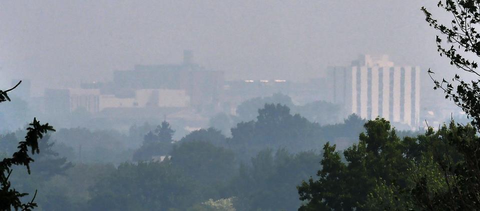 Buildings in downtown Erie, normally visible from West Grandview Boulevard, are shrouded in a smoky haze on June 28, 2023.