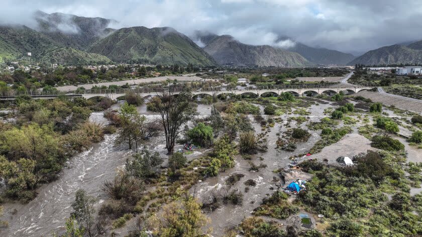 Azusa, CA, Tuesday, March 21, 2023 - The rain swollen San Gabriel River flows south below a pedestrian bridge between Duarte and Azusa. (Robert Gauthier/Los Angeles Times)