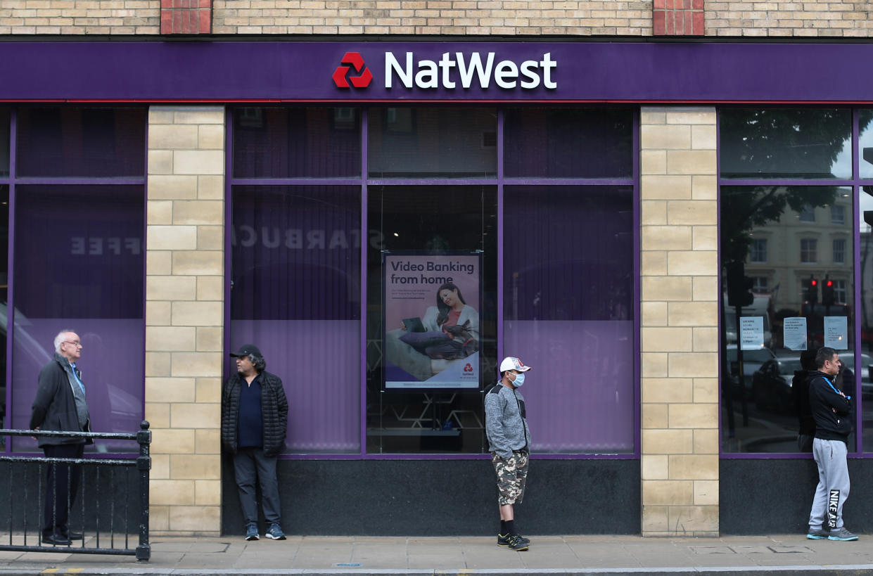 People maintain social distance while they queue outside a Natwest bank in Wimbledon, following the outbreak of the coronavirus disease (COVID-19), London, Britain, May 1, 2020. REUTERS/Hannah McKay