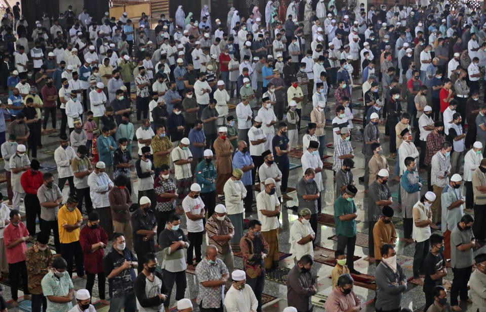 Muslim men pray amid concerns of the new coronavirus outbreak during a Friday prayer at At-Tin mosque in Jakarta, Indonesia, Friday, June 5, 2020. Muslims in Indonesia's capital held their first communal Friday prayers as mosques closed by the coronavirus outbreak for nine weeks reopened at half capacity. (AP Photo/Achmad Ibrahim)