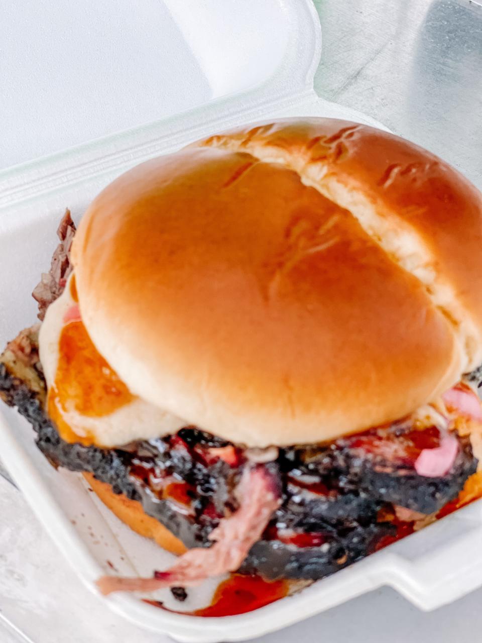 Food Fire and Ferment food truck’s Boozy Brisket — prime brisket on a brioche bun with beer-pickled red onions, beer cheese and bourbon sauce. March 4, 2022.