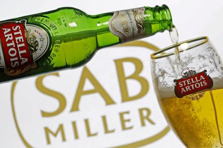 Photo illustration of beer flowing from a bottle of Stella Artois into a glass, part of the Anheuser-Busch InBev group, seen against a SABMiller logo, November 5, 2015. REUTERS/Dado Ruvic/Illustration/File Photo