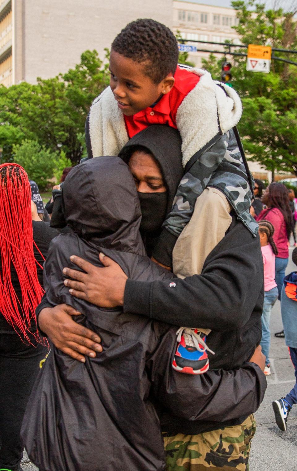 Protesters console each other following the shooting death of Omari Cryerin downtown Louisville on May 23, 2022. Cryer was killed last Friday.