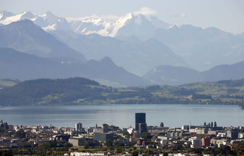 FILE PHOTO: Peaks of Bernese Oberland are seen behind Lake Zug and the city of Zug