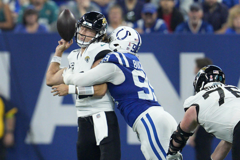 Jacksonville Jaguars quarterback Trevor Lawrence, left, fumbles as he is hit by Indianapolis Colts defensive tackle DeForest Buckner (99) during the second half of an NFL football game Sunday, Sept. 10, 2023, in Indianapolis. Buckner recovered the fumble and ran it back for a touchdown. (AP Photo/Jeff Dean)