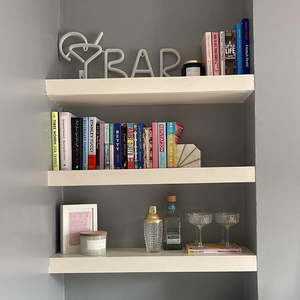 Living room built in shelves with books and accessories.