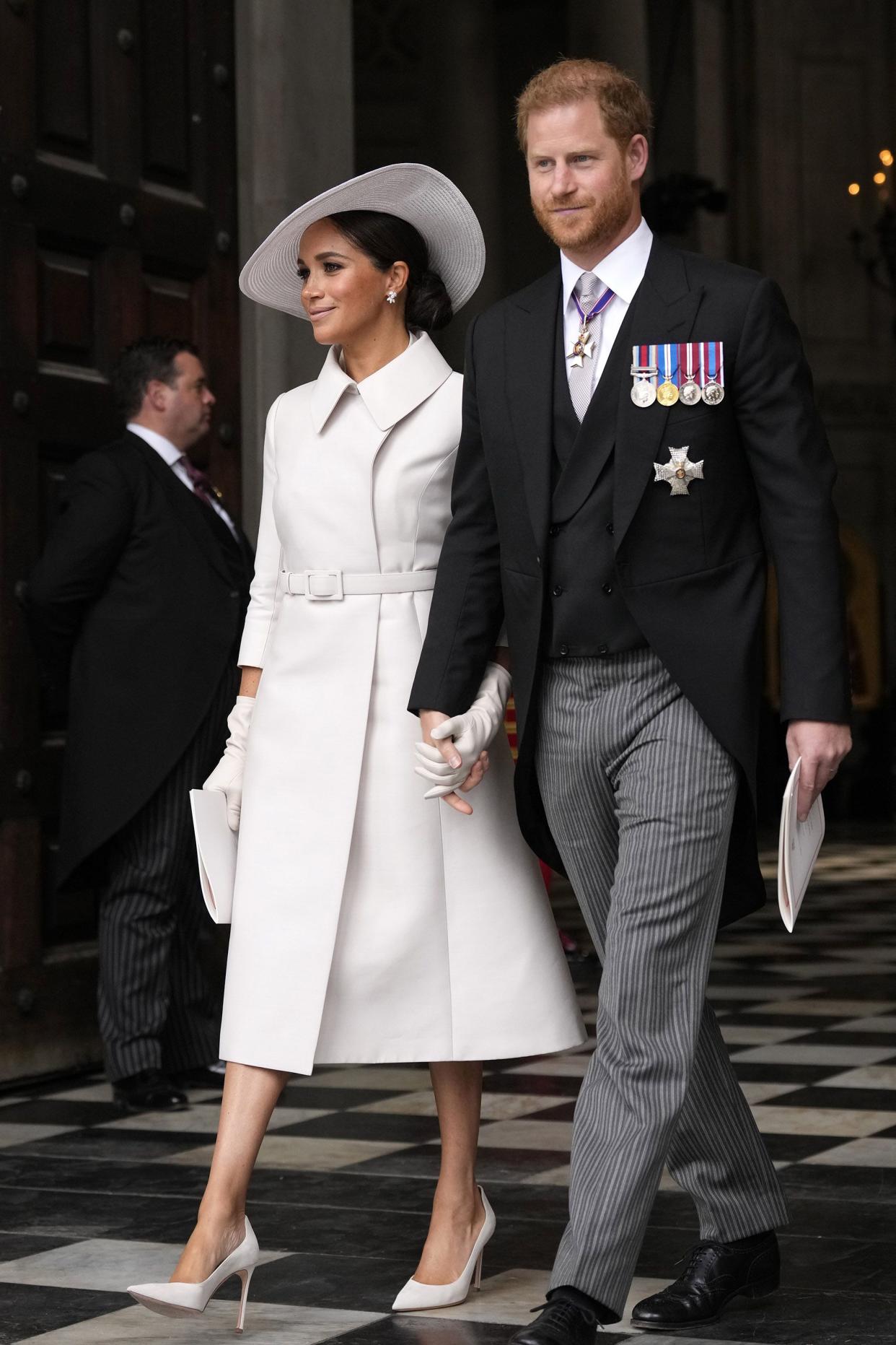 Prince Harry and Meghan Markle, Duke and Duchess of Sussex leave after a service of thanksgiving for the reign of Queen Elizabeth II at St Paul's Cathedral in London, Friday, June 3, 2022.