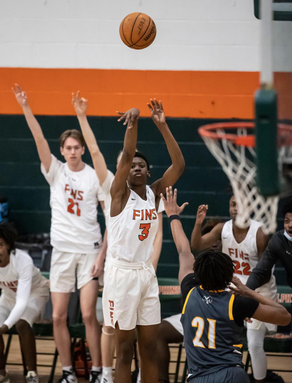 The bench knows its good as Dolphin Jakian Taylor puts up a three pointer. Mosley hosted Rutherford in boys basketball Friday, January 21, 2022.